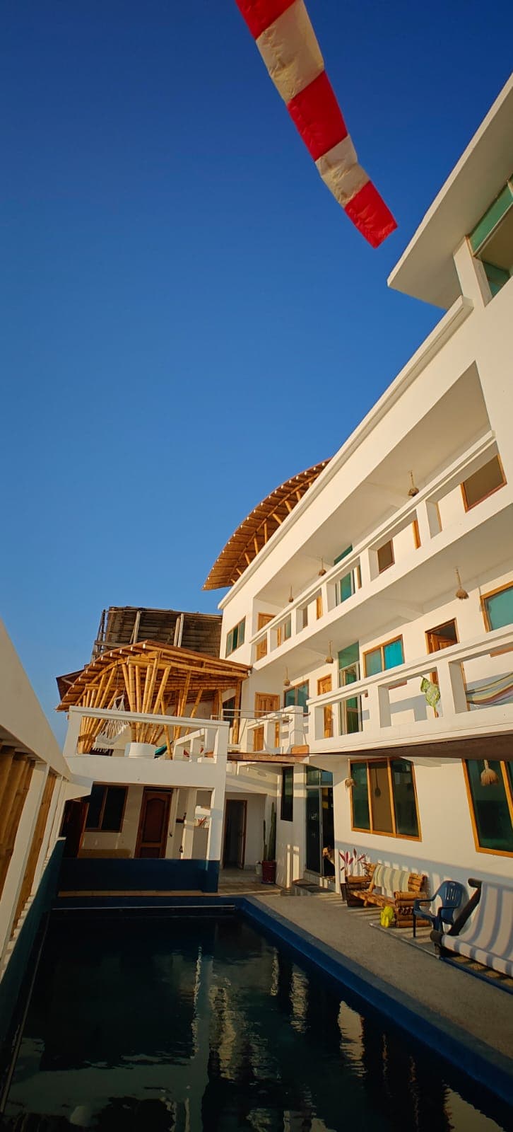 Swimming pool in the courtyard of Hostal Cruzita, with balconies on three floors above