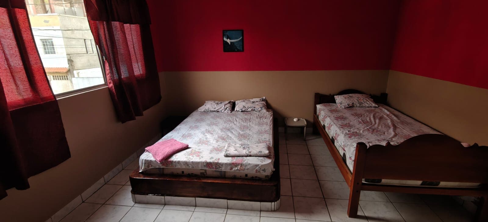 Room with two double beds and red walls