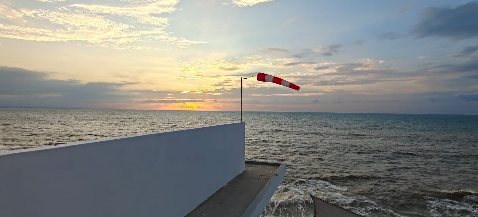 Windsock over the sea showing the steady onshore wind in Crucita